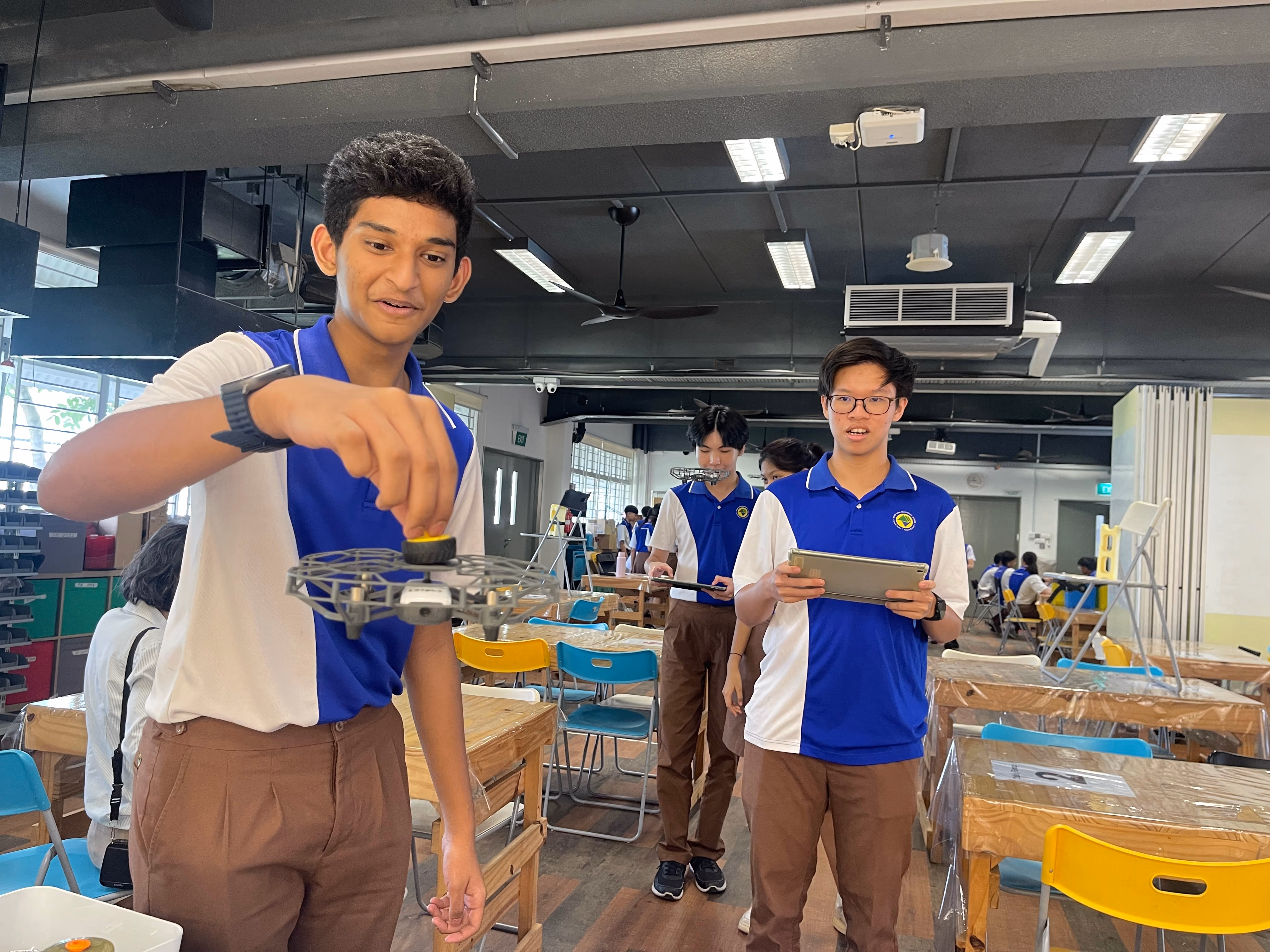 Enrichment for Students Taking Computer Applications Secondary Three students participated in a Tello drones workshop, where they learned the basics of drone operation, including First-Person View (FPV) flying and programming drones for autonomous flight using the DroneBlocks app. The workshop concluded with an exciting course challenge that allowed students to test and showcase their drone control skills.